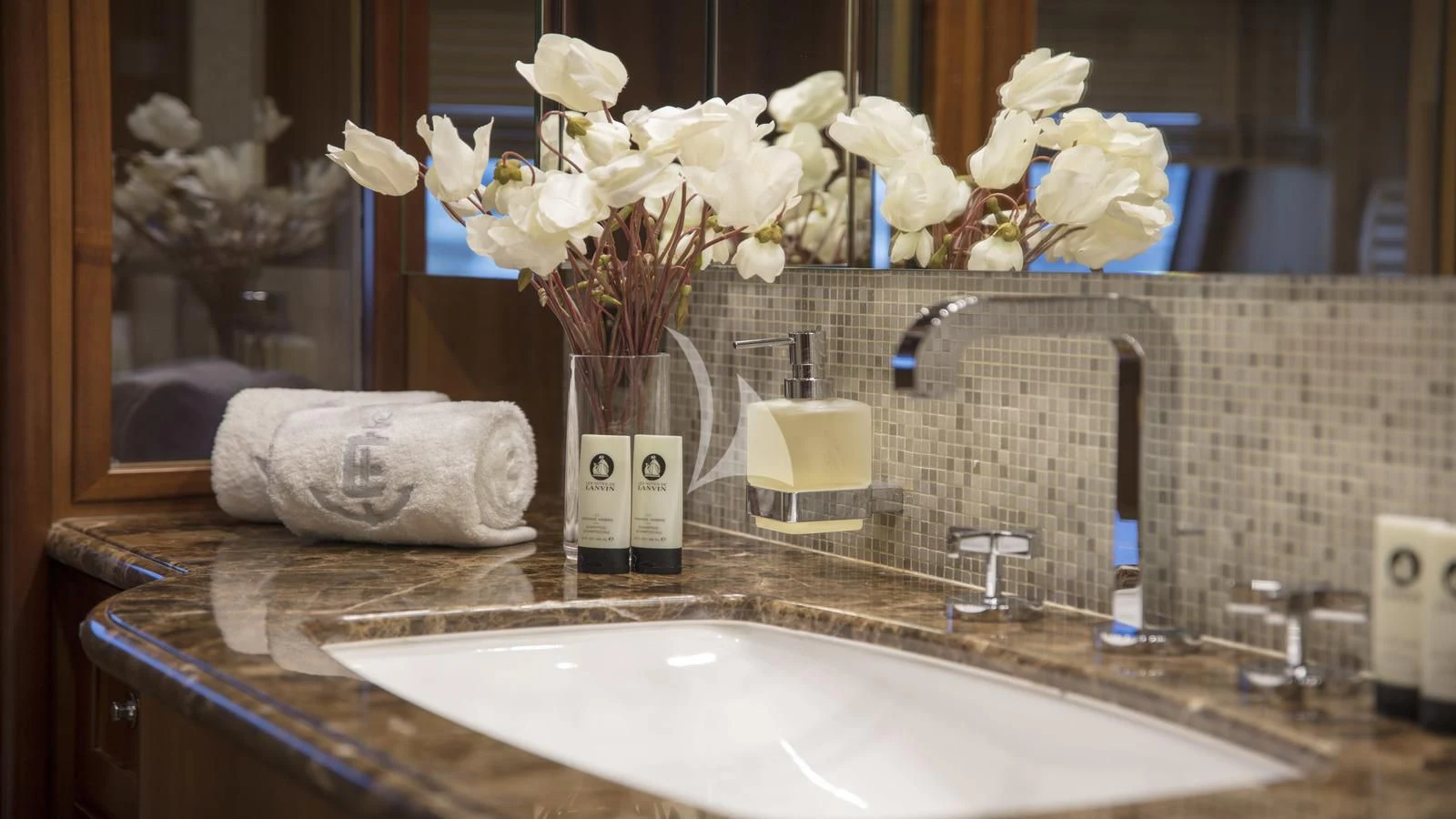 a vase of white flowers on a counter top aboard ENA Yacht for Sale