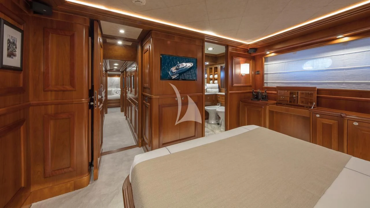 a room with a bed and cabinets aboard ENA Yacht for Sale