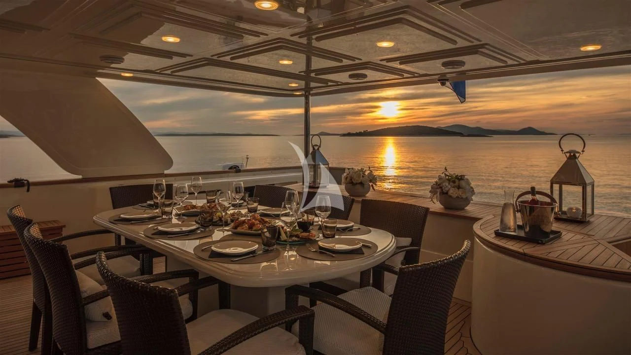 a dining room with a table set for a meal aboard ENA Yacht for Sale