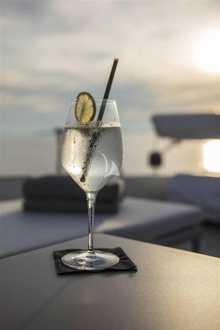 a glass of beer on a table aboard ENA Yacht for Sale
