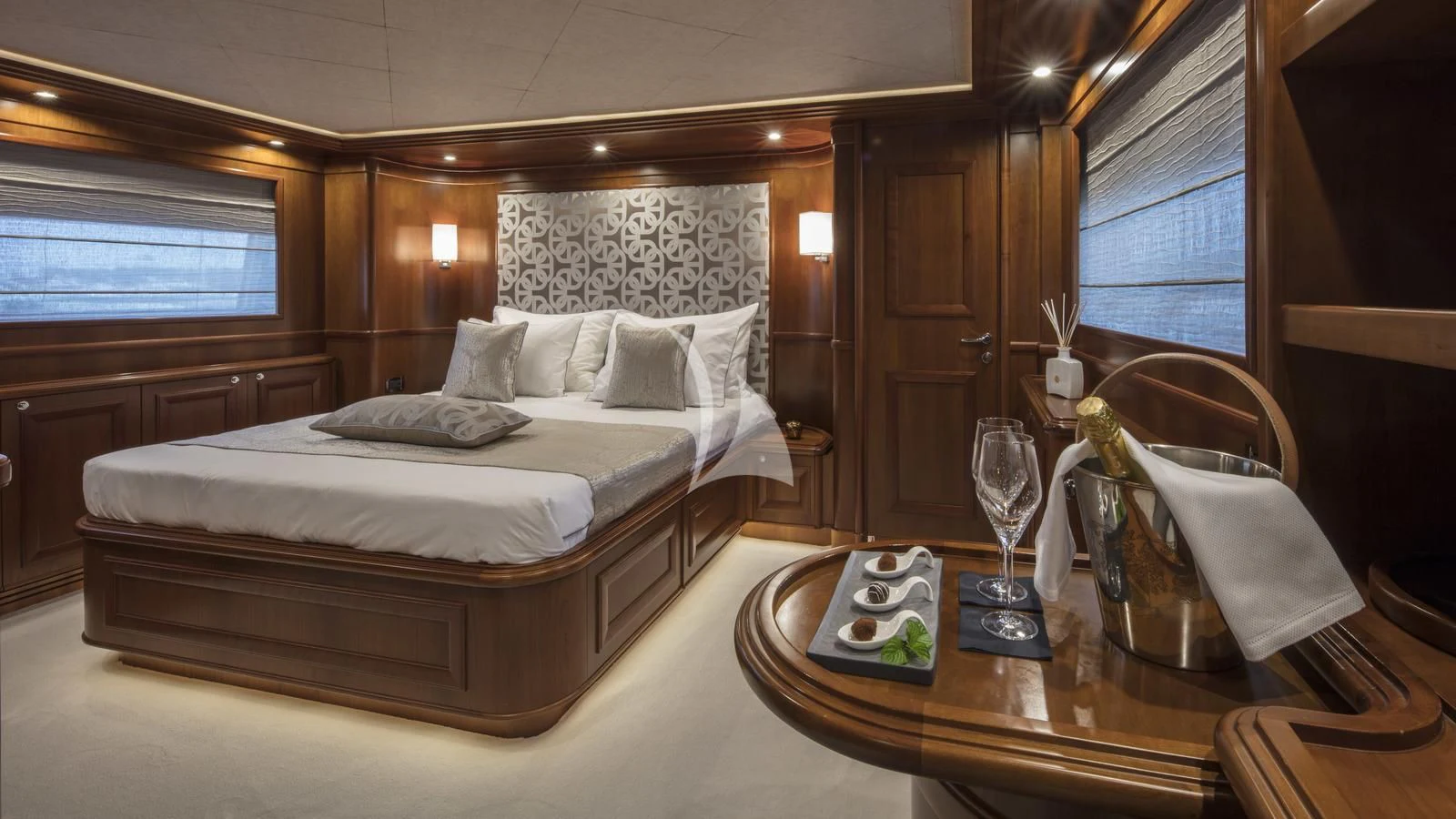 a bed with a table and chairs aboard ENA Yacht for Sale