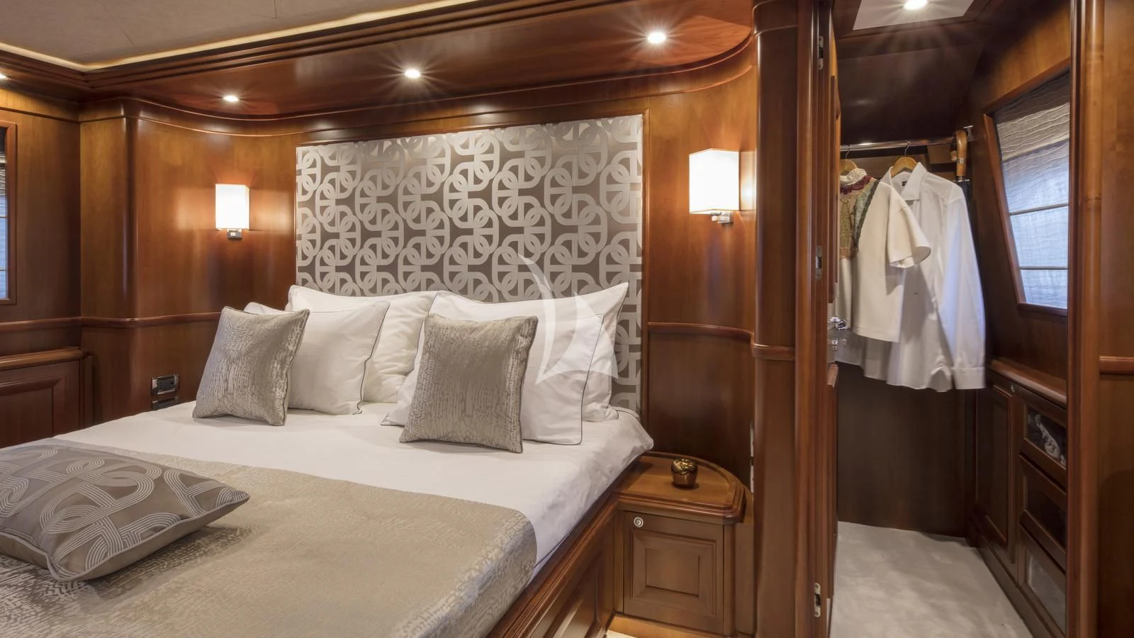 a bed with white sheets and pillows aboard ENA Yacht for Sale