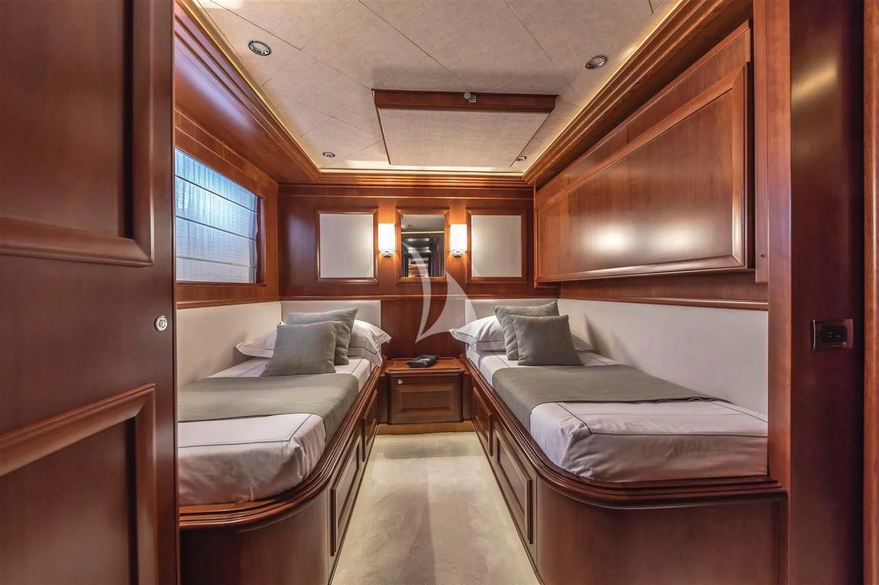 a room with beds and a window aboard ENA Yacht for Sale