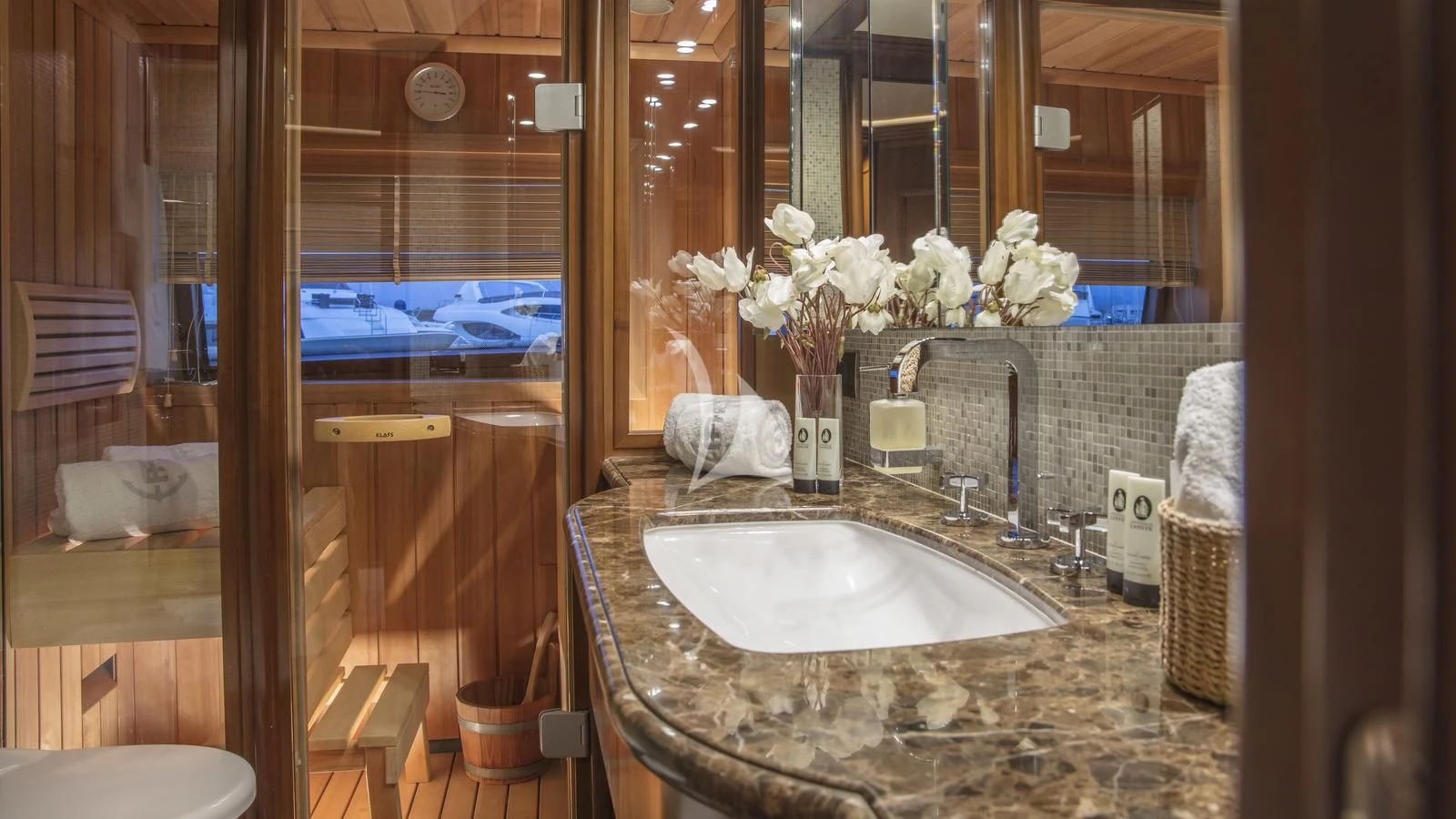 a bathroom with a sink and a large mirror aboard ENA Yacht for Sale