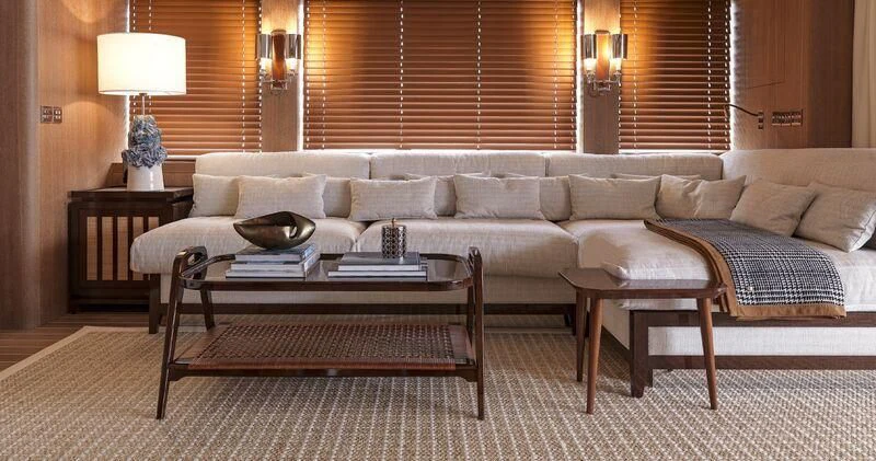 a living room with a couch and coffee table aboard PAIZA ONE Yacht for Sale