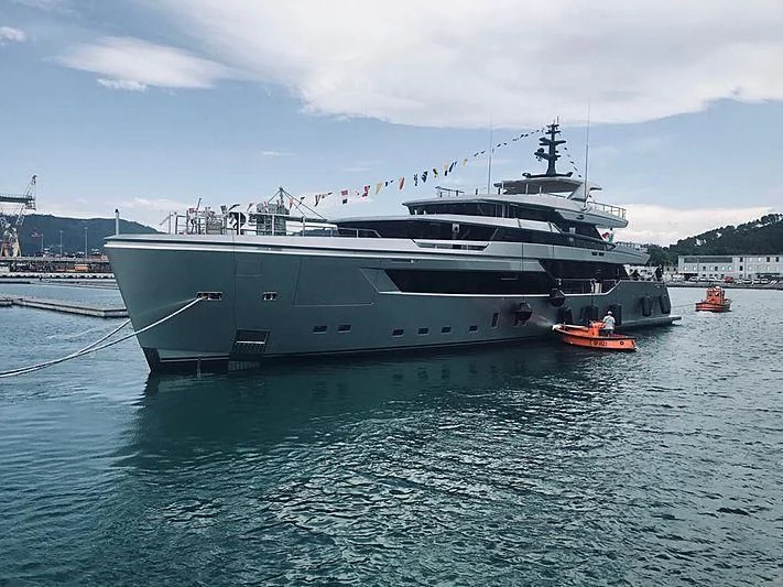 a large white boat in a harbor aboard PAIZA ONE Yacht for Sale