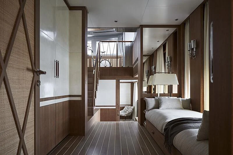 a bedroom with a bed and a mirror aboard PAIZA ONE Yacht for Sale
