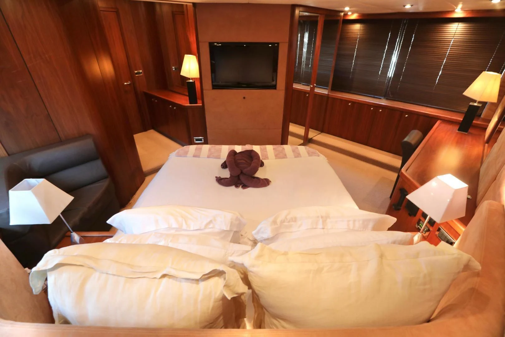 a hotel room with a bed and a television aboard CAPRICHO II Yacht for Sale