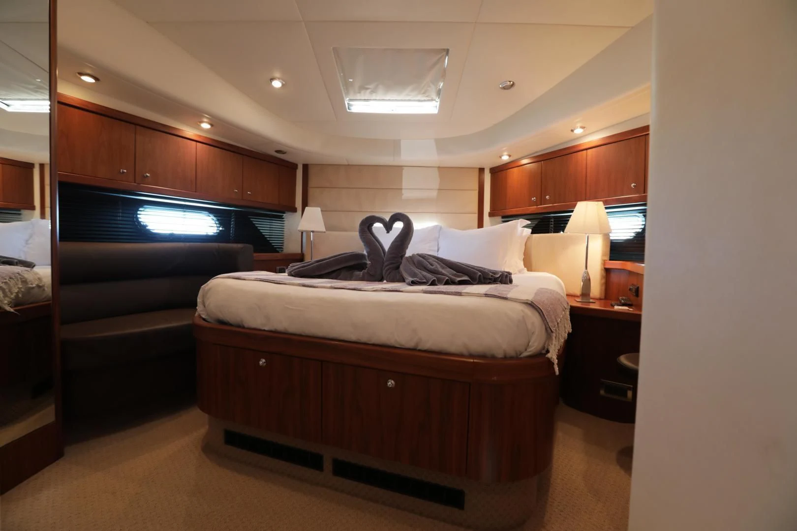 a bedroom with a bed and a tv aboard CAPRICHO II Yacht for Sale