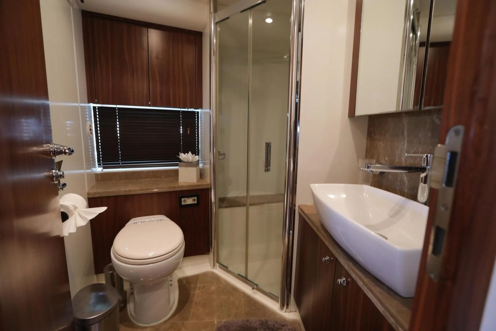 a bathroom with a toilet and sink aboard CAPRICHO II Yacht for Sale