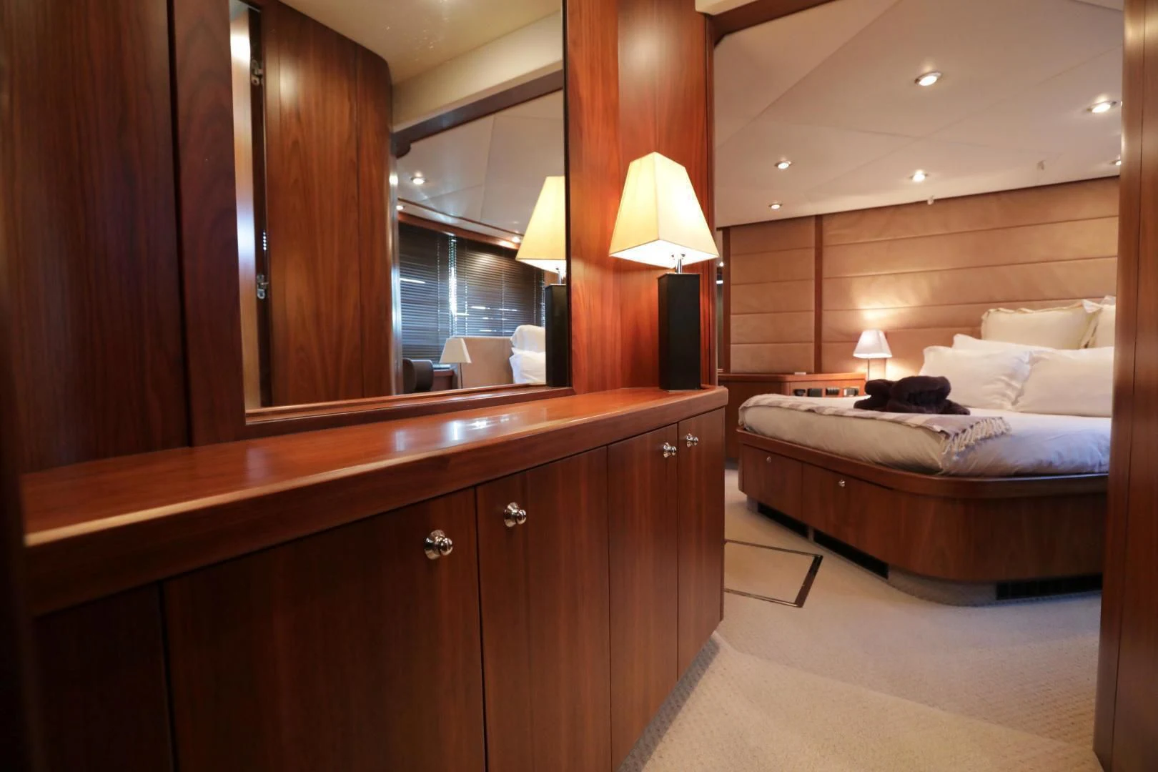 a bedroom with a bed and a desk aboard CAPRICHO II Yacht for Sale