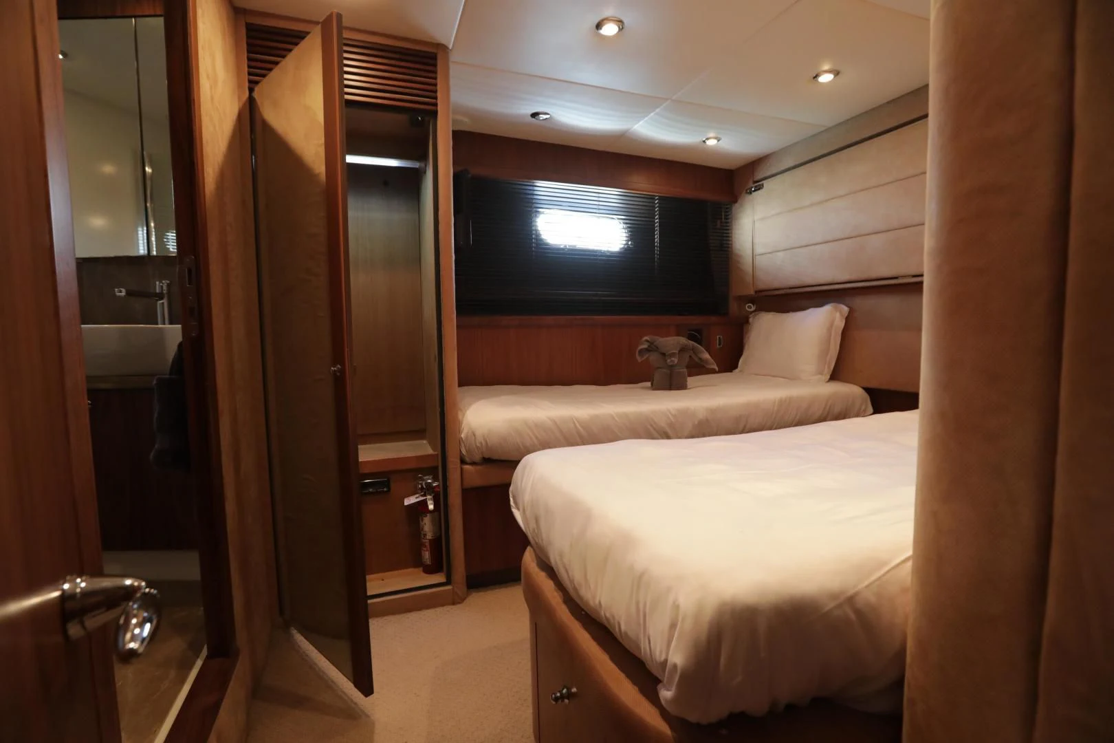 a room with a bed and a mirror aboard CAPRICHO II Yacht for Sale