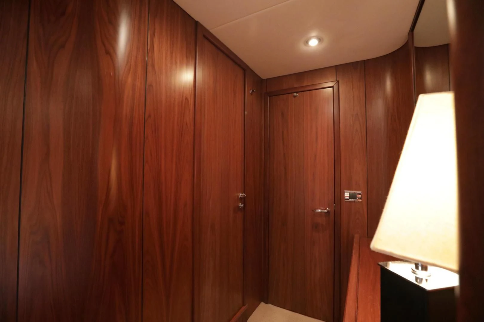 a lamp next to a wood wall aboard CAPRICHO II Yacht for Sale