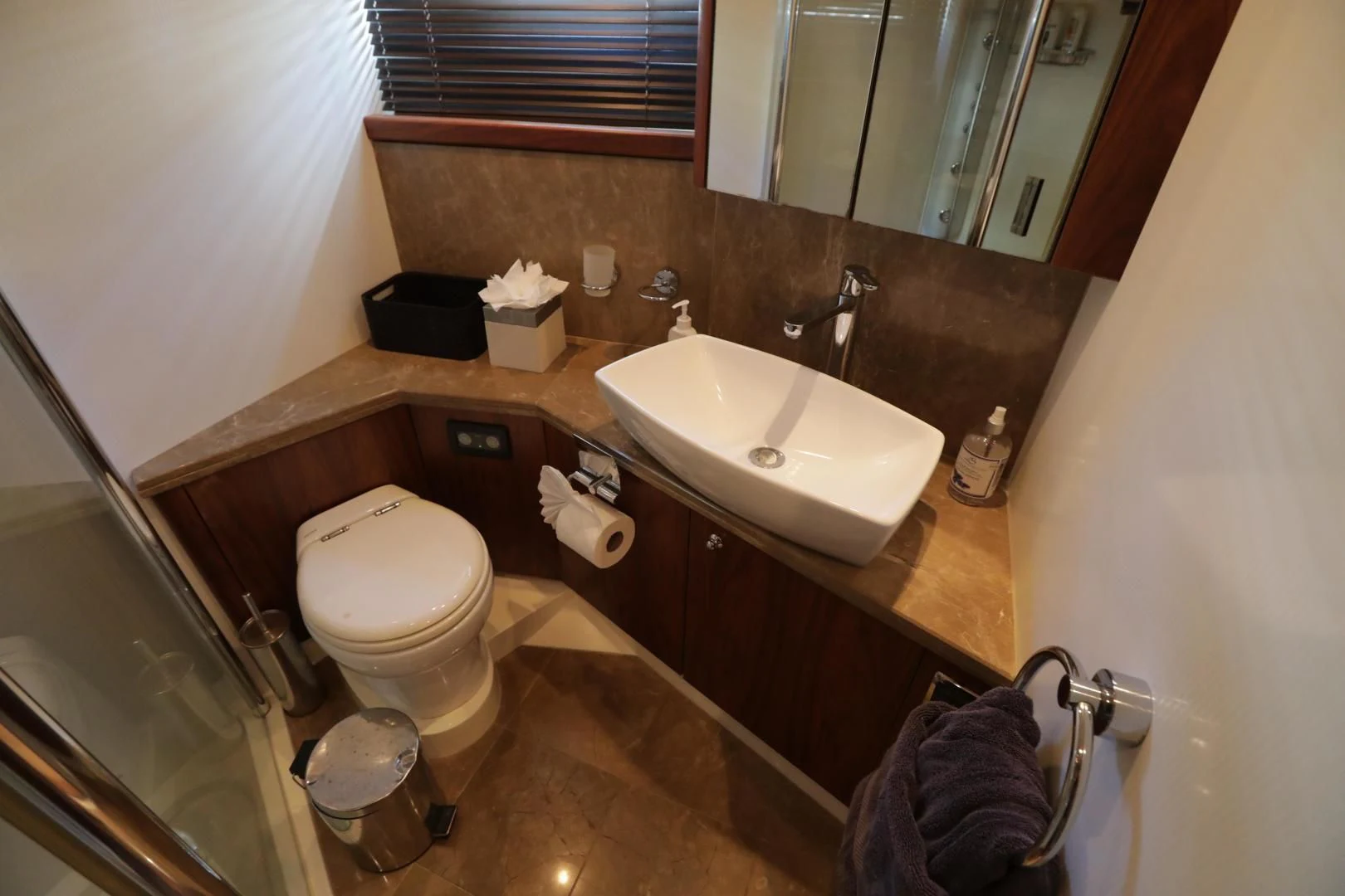 a bathroom with a sink and toilet aboard CAPRICHO II Yacht for Sale