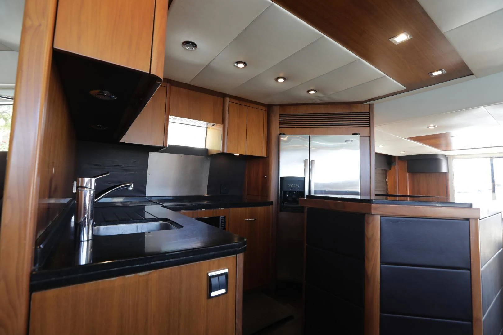 a kitchen with wooden cabinets aboard CAPRICHO II Yacht for Sale