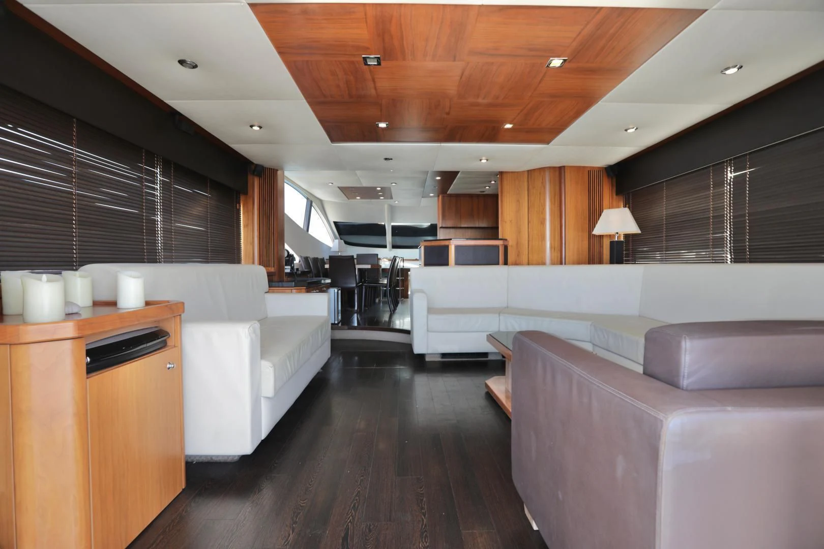 a living room with a wood floor aboard CAPRICHO II Yacht for Sale