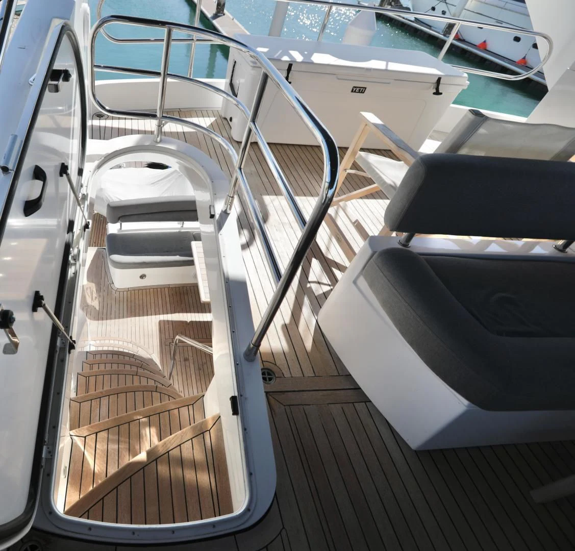 a group of white chairs aboard CAPRICHO II Yacht for Sale