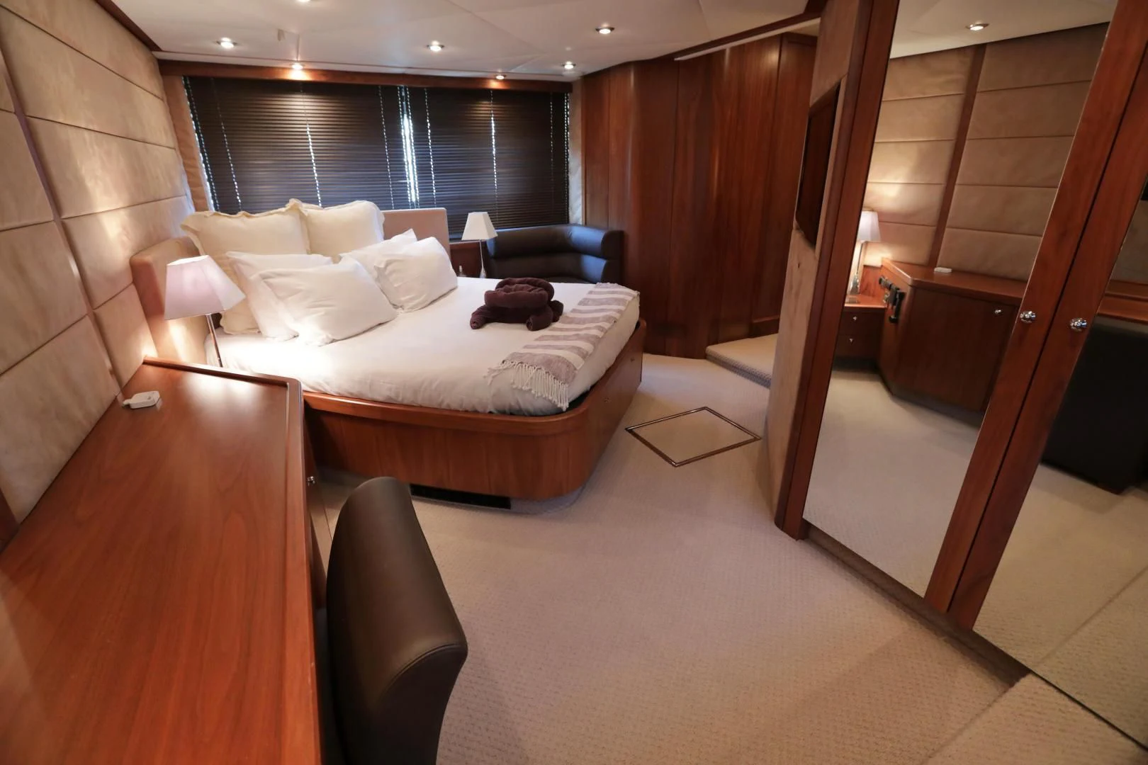 a hotel room with a bed and a desk aboard CAPRICHO II Yacht for Sale