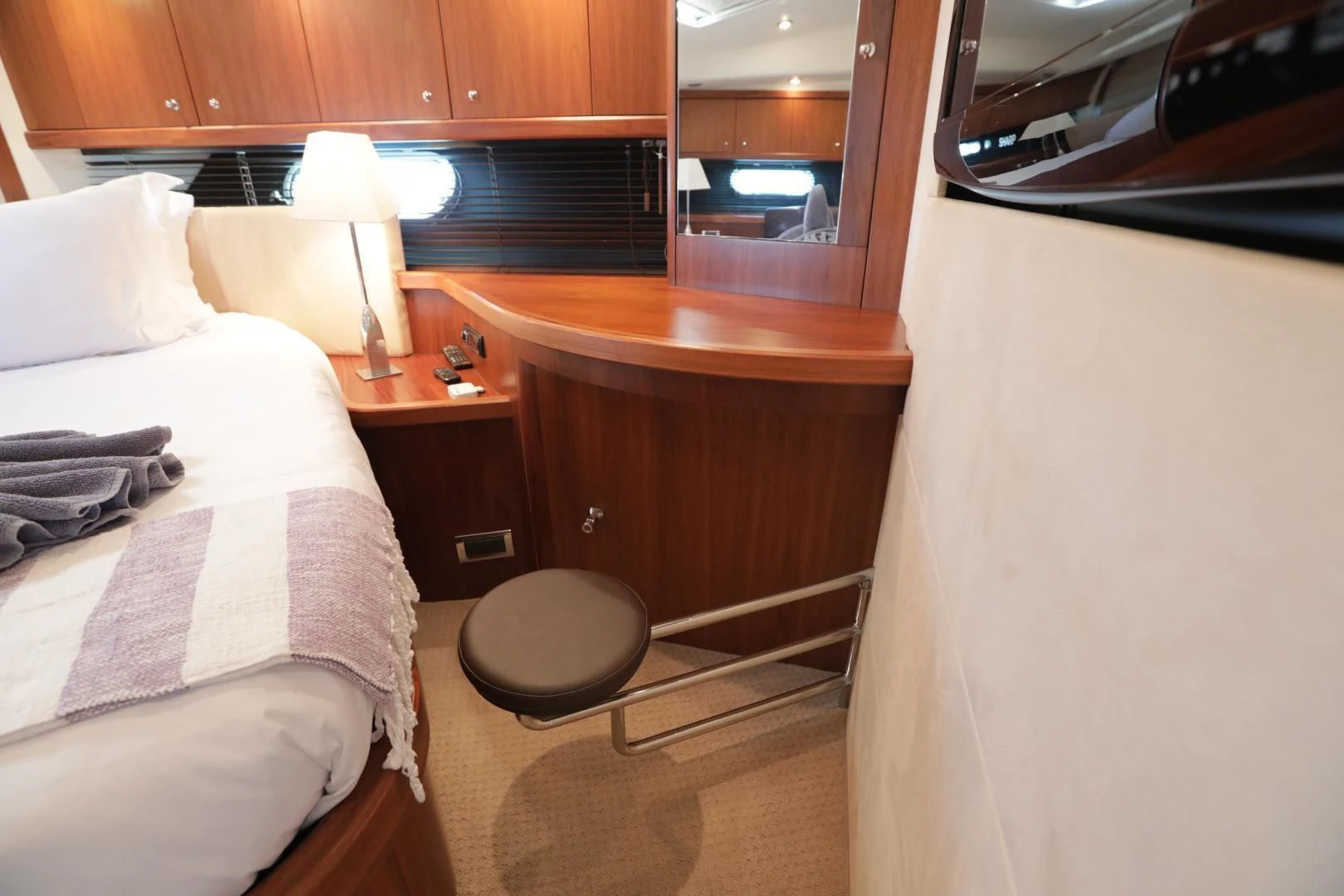 a room with a bed and a table aboard CAPRICHO II Yacht for Sale
