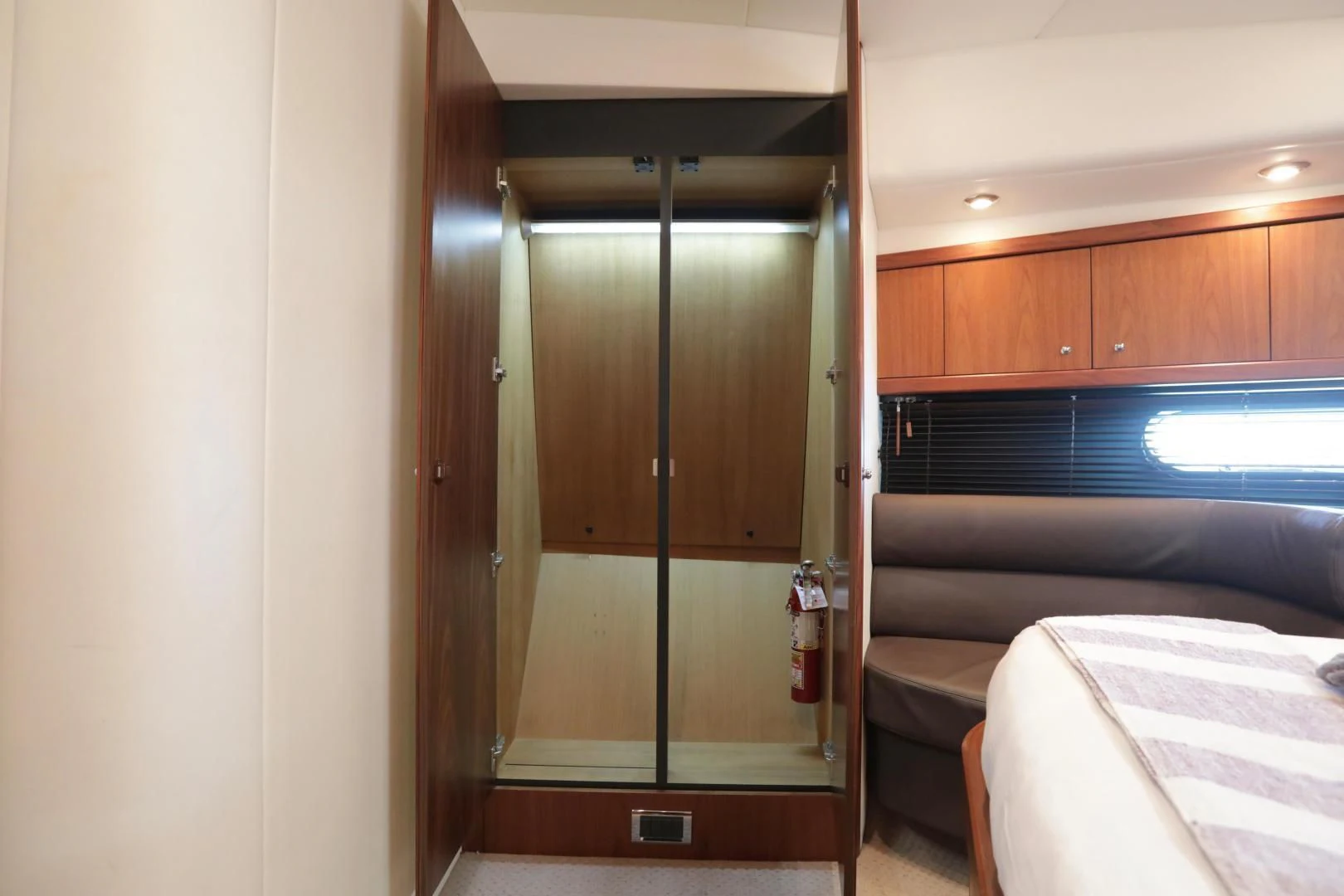 a room with a bed and a closet aboard CAPRICHO II Yacht for Sale