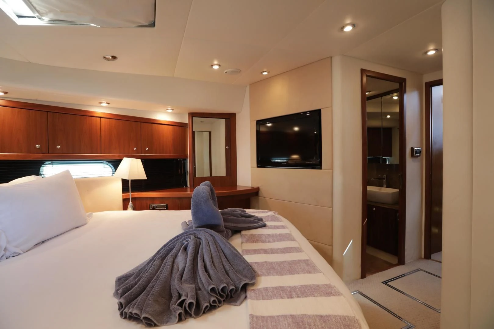 a hotel room with a bed and tv aboard CAPRICHO II Yacht for Sale
