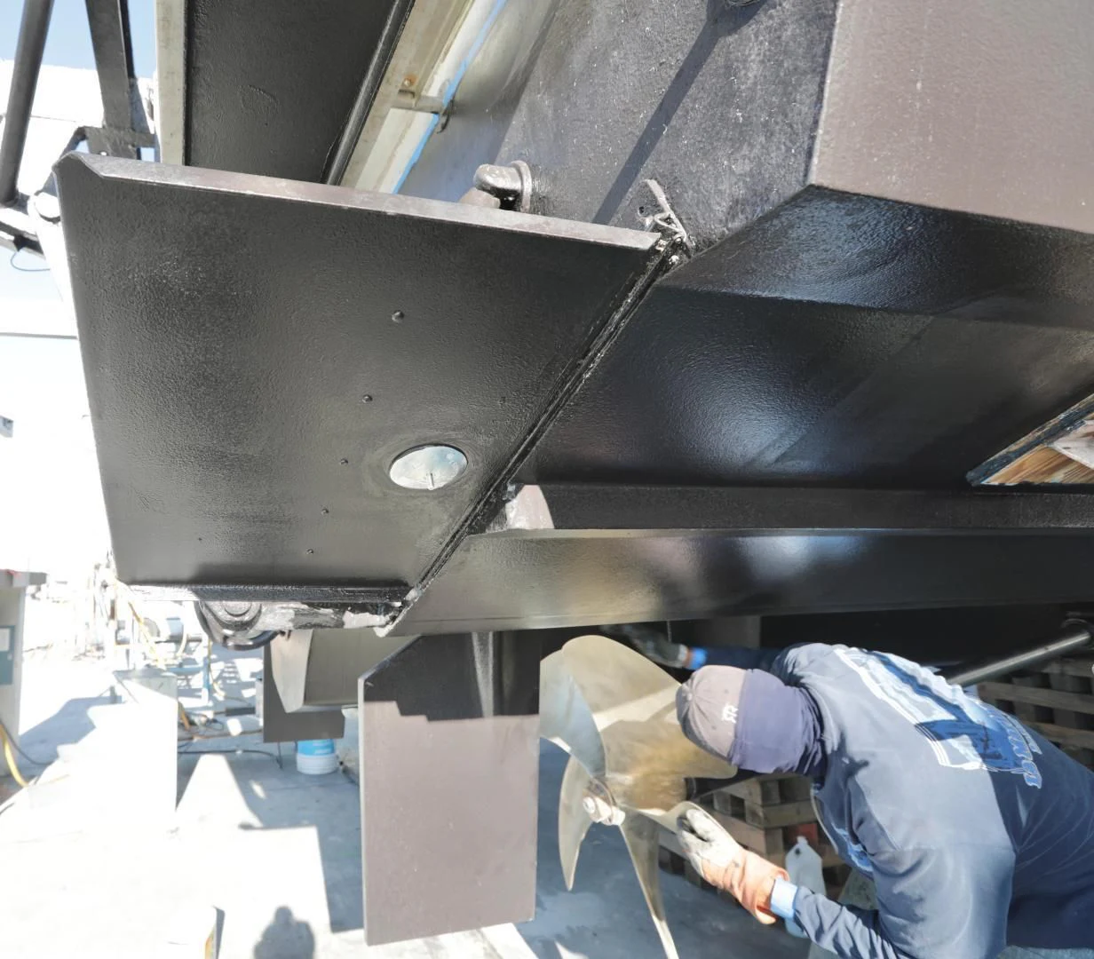 a person working on a machine aboard CAPRICHO II Yacht for Sale