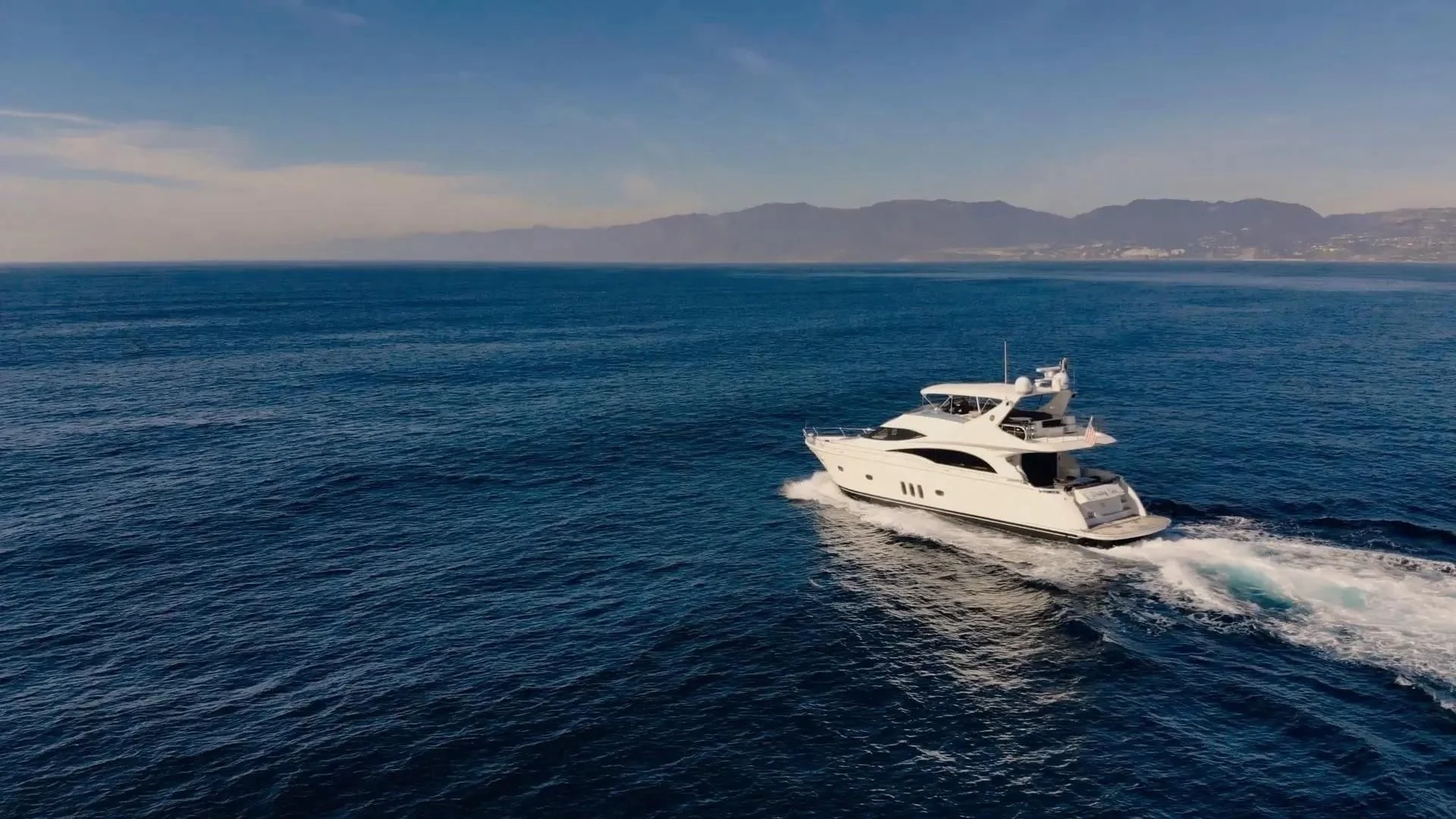 a white boat on the water aboard STARTING OVER Yacht for Sale