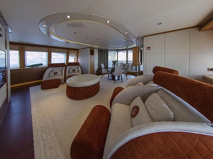 a large living room with a large chandelier aboard SHARKFINN Yacht for Sale