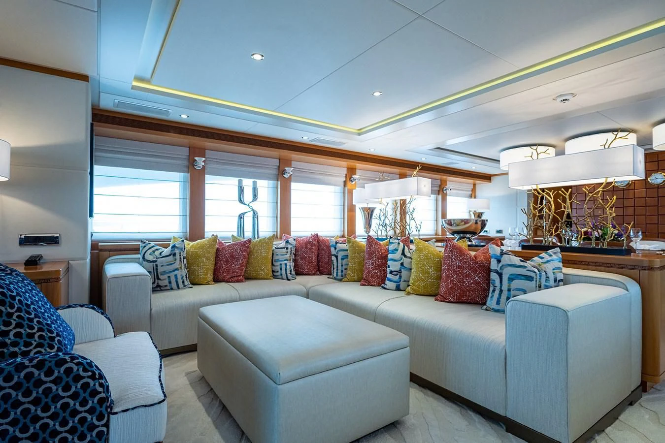 a living room with a couch and a large window aboard SHARKFINN Yacht for Sale
