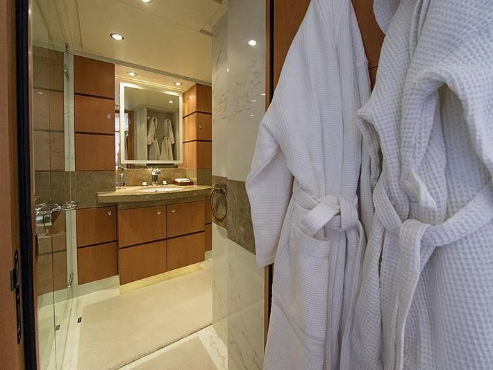 a bathroom with a robe and a sink aboard SHARKFINN Yacht for Sale