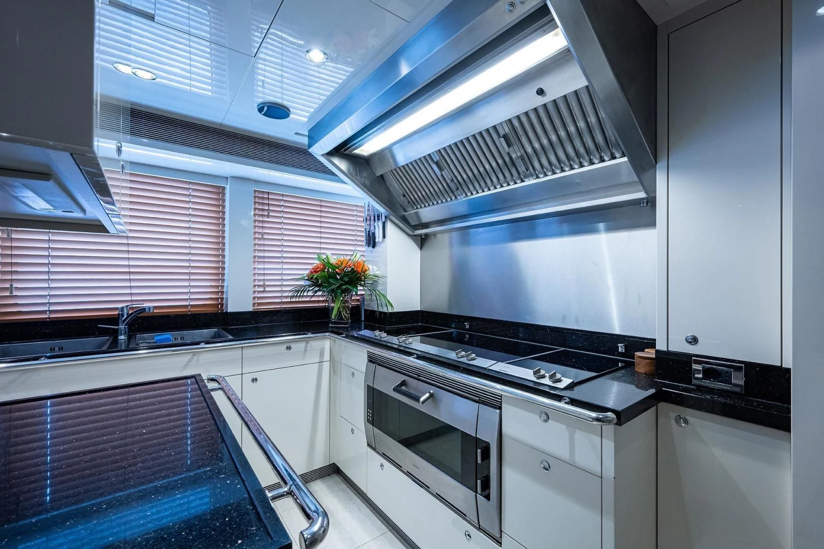 a kitchen with a stove and a vent aboard SHARKFINN Yacht for Sale
