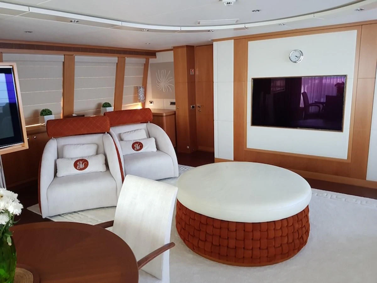 a living room with a large screen aboard SHARKFINN Yacht for Sale