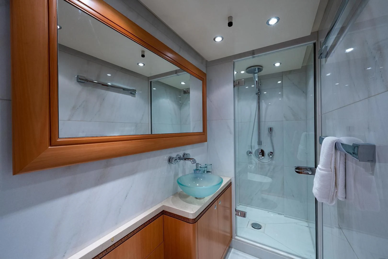 a bathroom with a glass shower aboard SHARKFINN Yacht for Sale