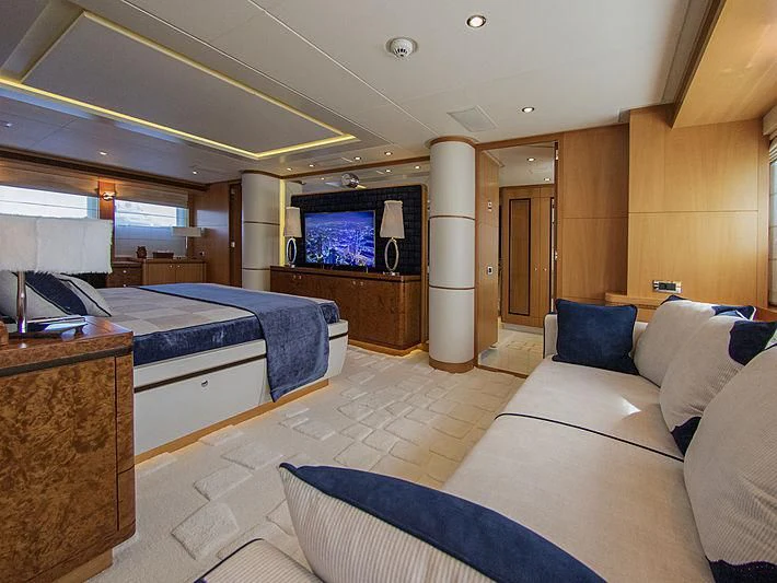 a bedroom with a bed and a television aboard SHARKFINN Yacht for Sale