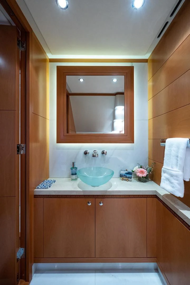 a bathroom with a sink and mirror aboard SHARKFINN Yacht for Sale