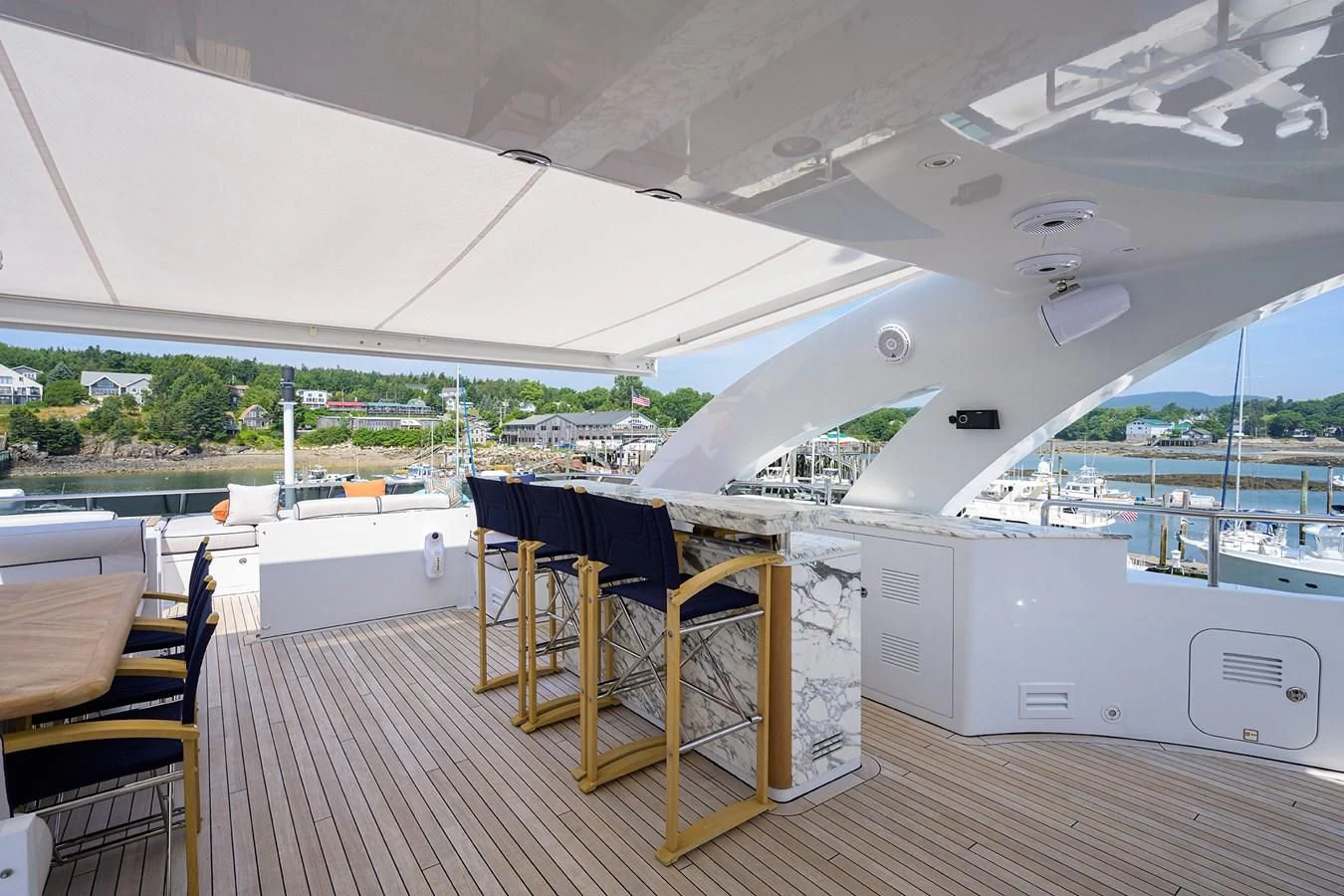 a deck with a table and chairs aboard SHARKFINN Yacht for Sale