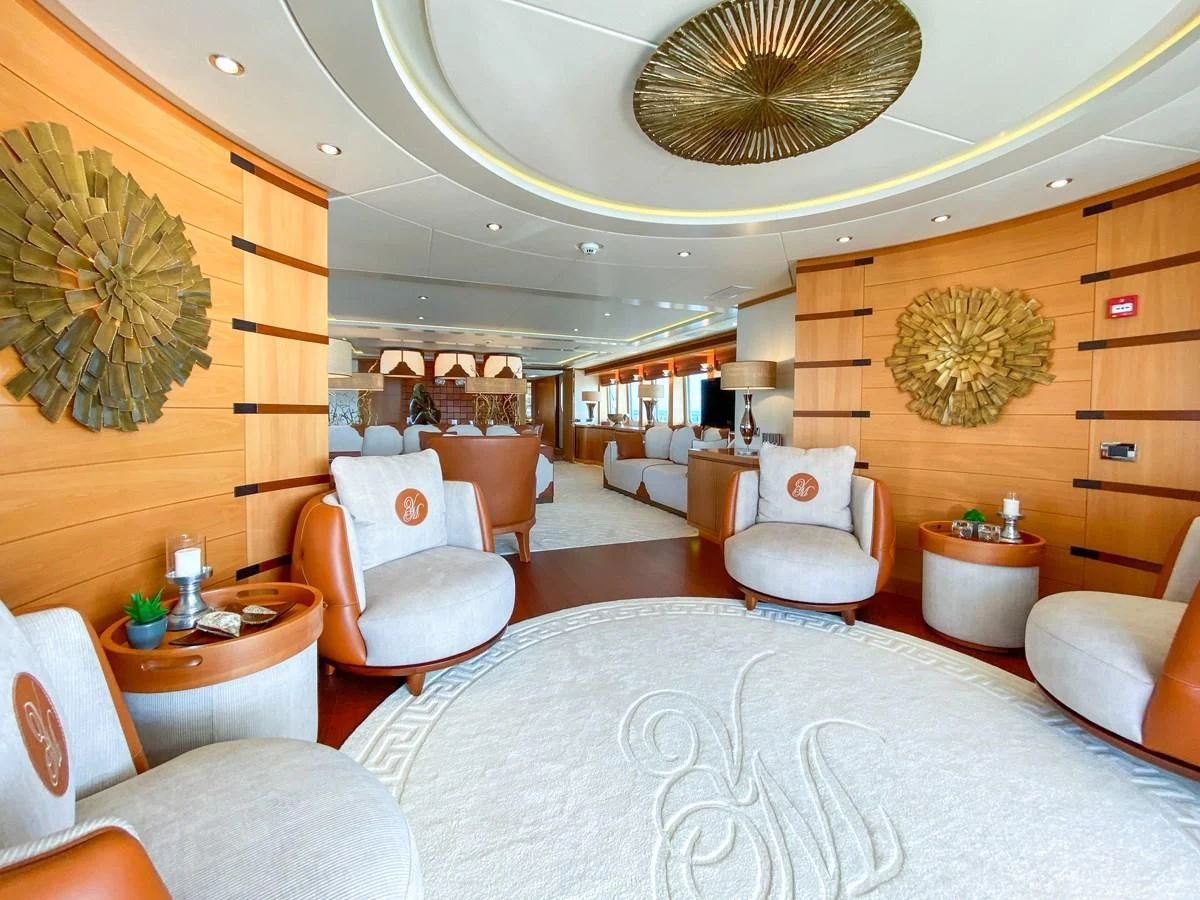 a large living room with a large chandelier aboard SHARKFINN Yacht for Sale