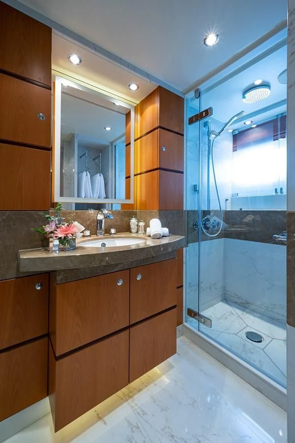 a bathroom with a sink and a shower aboard SHARKFINN Yacht for Sale