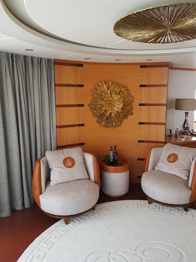 a room with a bed and a chair aboard SHARKFINN Yacht for Sale
