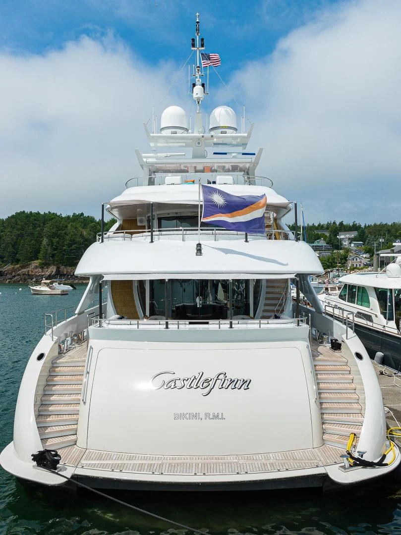 a boat with a flag on the front aboard SHARKFINN Yacht for Sale