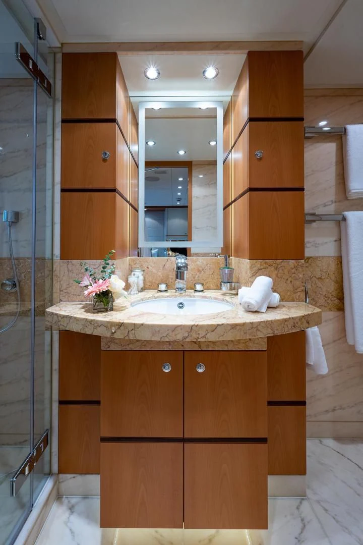 a bathroom with a sink and a shower unit aboard SHARKFINN Yacht for Sale