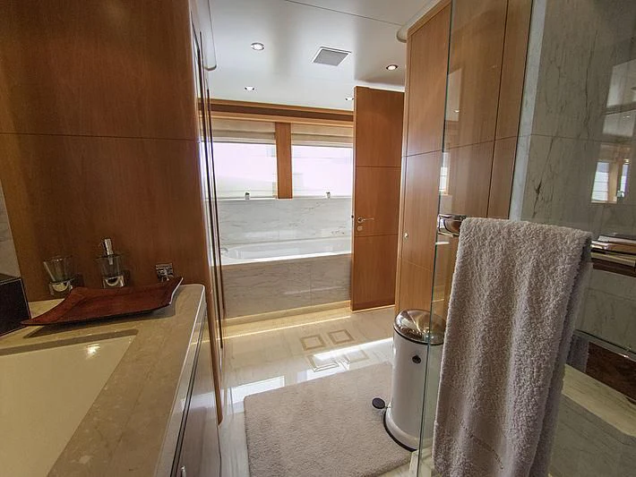 a bathroom with a glass shower aboard SHARKFINN Yacht for Sale