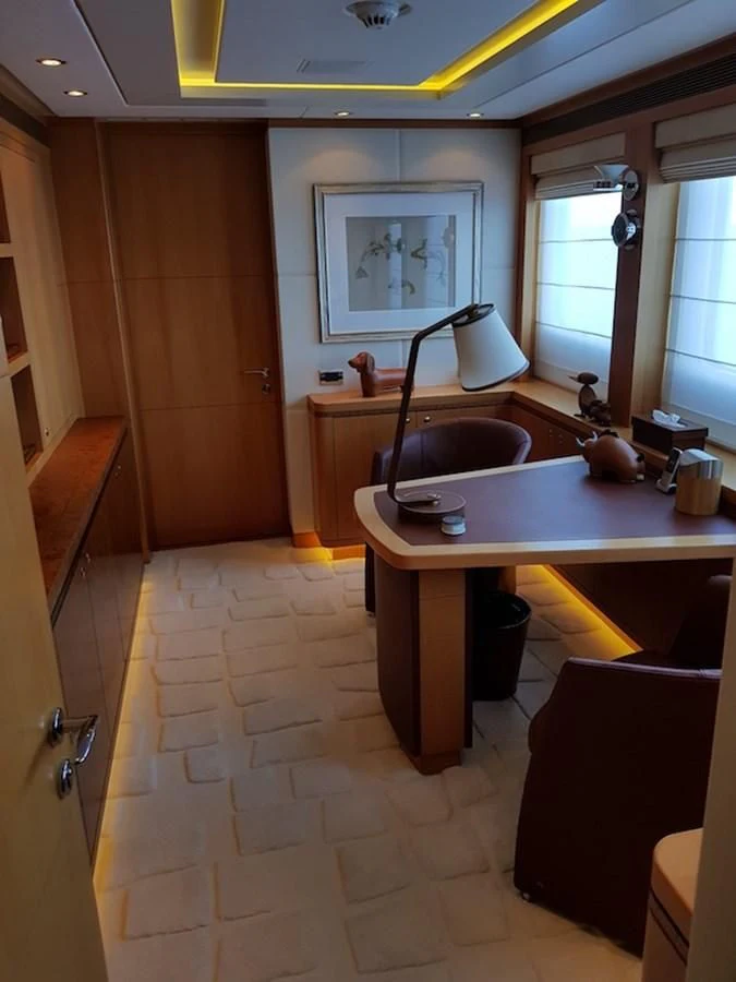 a kitchen with a table and chairs aboard SHARKFINN Yacht for Sale