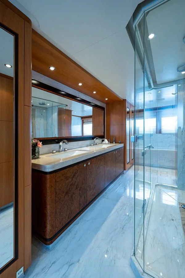 a bathroom with a glass shower aboard SHARKFINN Yacht for Sale