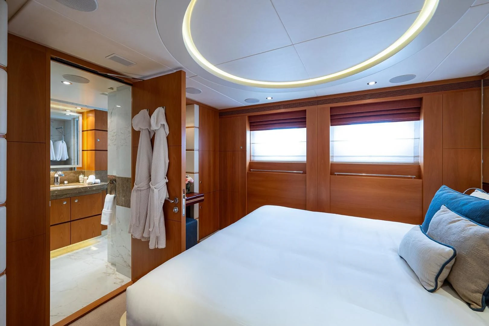 a bedroom with a bed and a mirror aboard SHARKFINN Yacht for Sale
