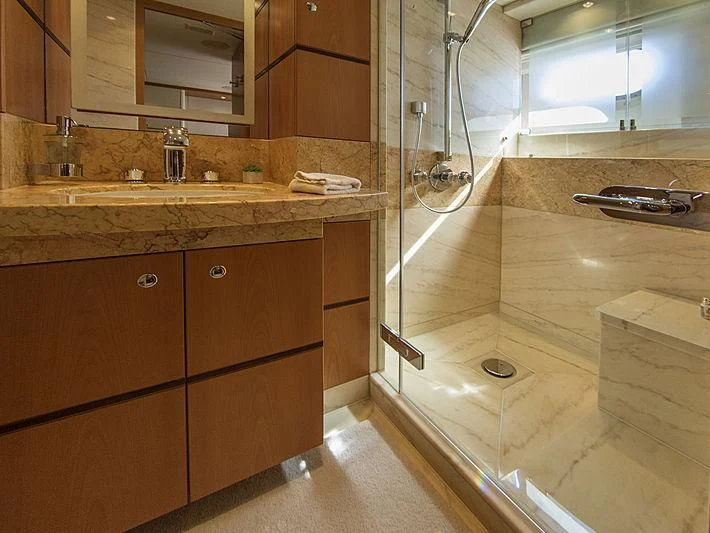 a bathroom with a shower unit and sink aboard SHARKFINN Yacht for Sale