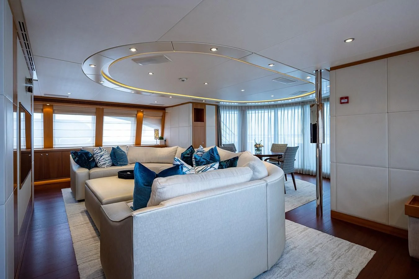 a living room with a large chandelier aboard SHARKFINN Yacht for Sale