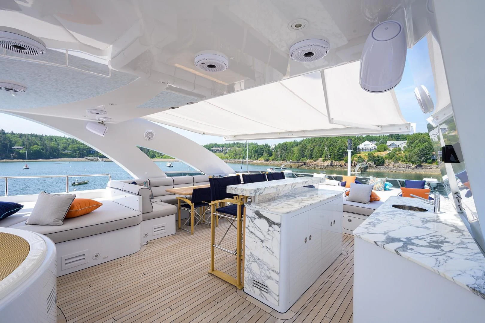 a room with a large white bed and a large white table with chairs aboard SHARKFINN Yacht for Sale