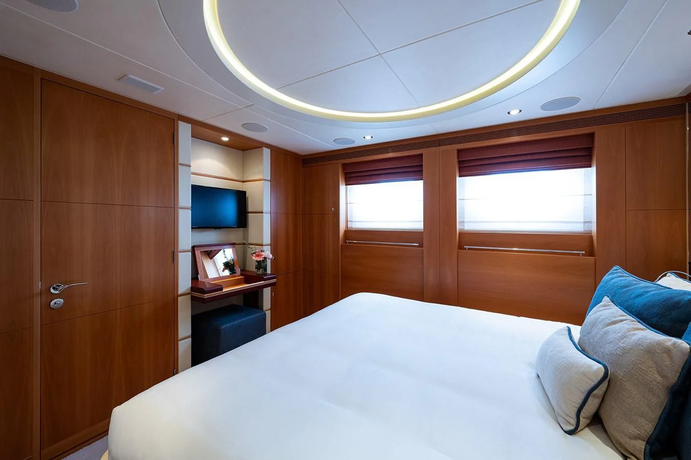a bedroom with a bed and a desk aboard SHARKFINN Yacht for Sale