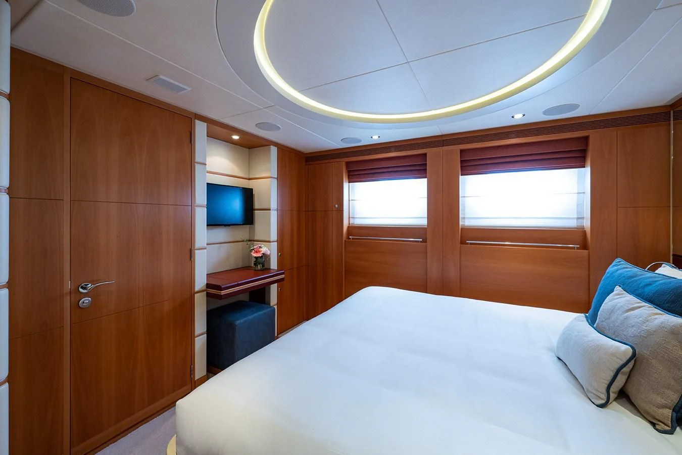 a bedroom with a bed and a television aboard SHARKFINN Yacht for Sale